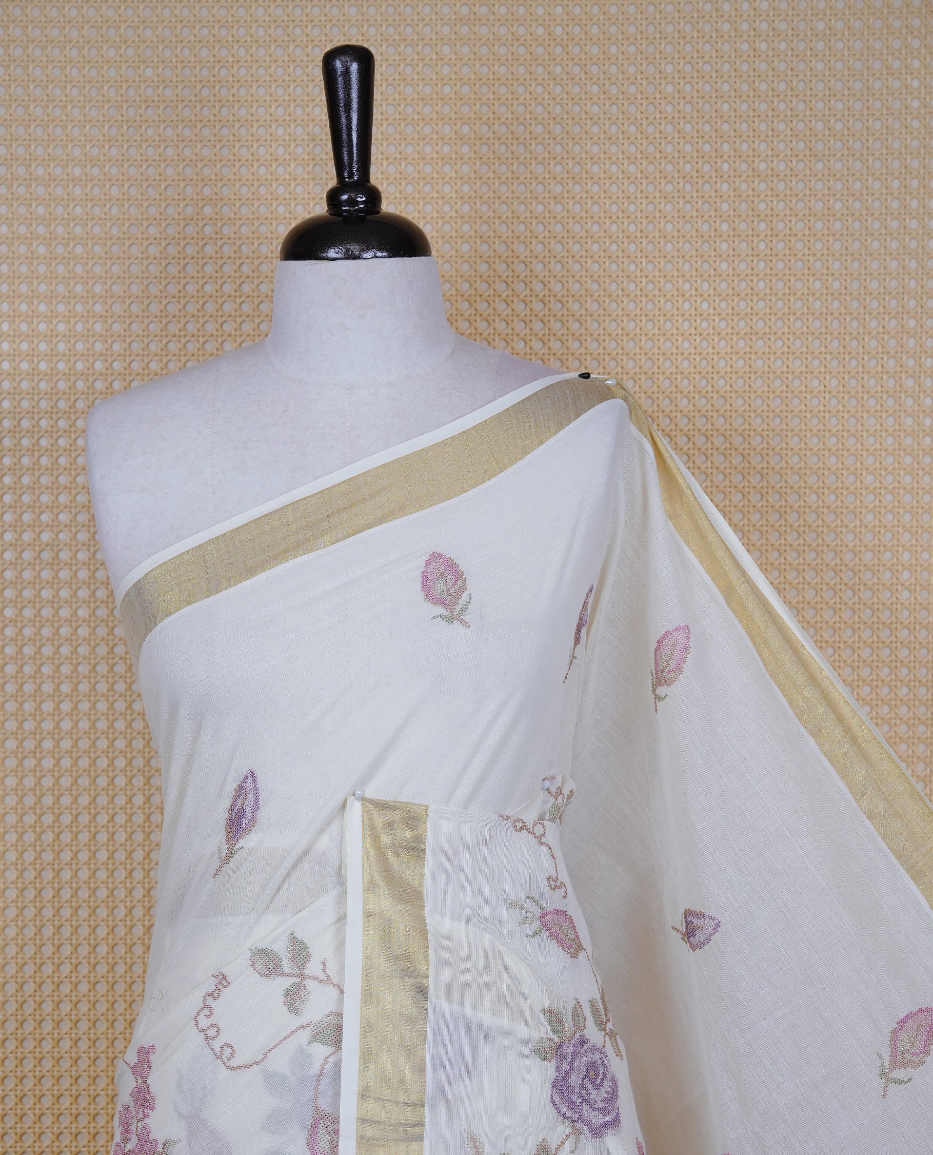 Cream colour Cotton Kerala saree featuring Floral Thread Embroidery work on body, complemented by gold kasavu Border, comes with matching blouse piece.