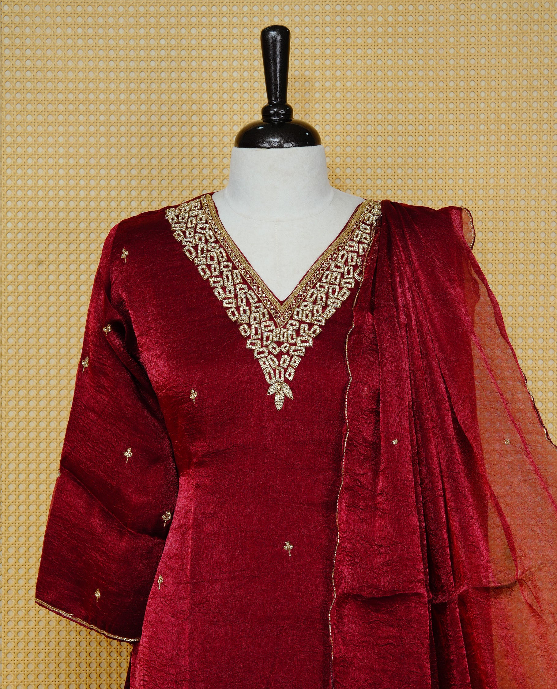 Wine red churidar set with stone and bead embroidery on the V-neckline & Body , paired with a matching embellished dupatta and solid pants.