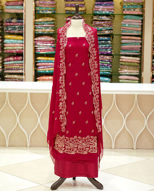 Rani pink colour georgette salwar set featuring gold zari buttas on body, floral embroidery and scalp work on dupatta, paired with matching bottom.