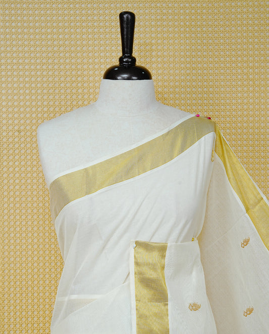Cream Colour Cotton Kerala Saree Featuring Delicate Gold Mango Motifs Across The Body, Enhanced With A Traditional Gold Zari Border, A Gold  Mango & Striped Gold Zari Pallu, Finished With A Matching Blouse Piece