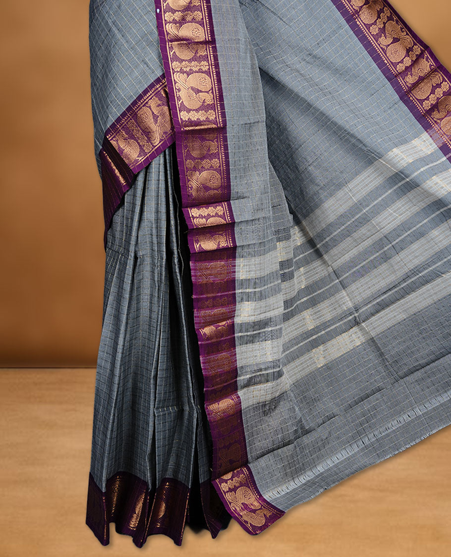 Grey colour sungudi cotton saree featuring gold zari check pattern across body, contrast Purple colour with gold zari peacock pattern on border, without blouse piece.