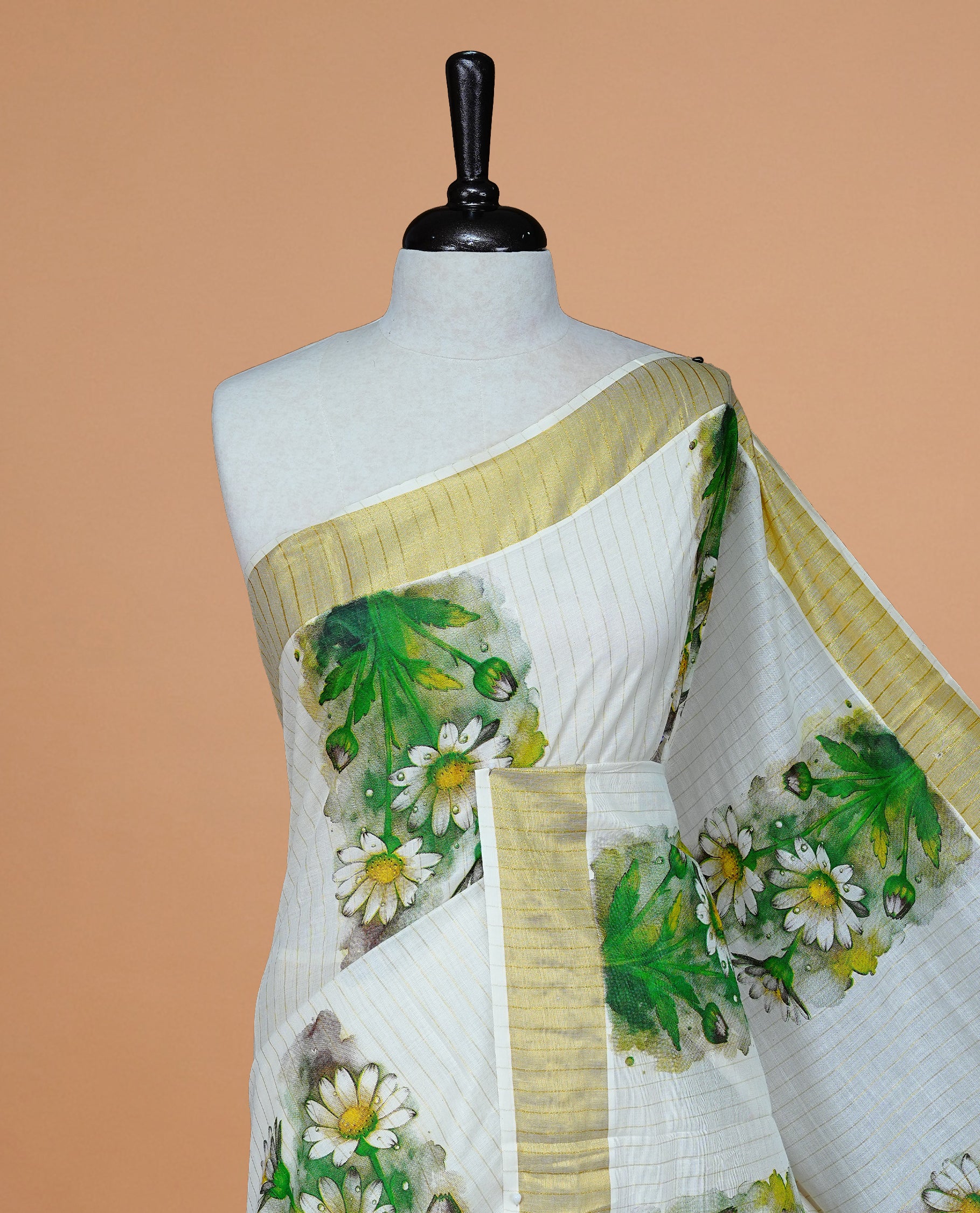 Cream Color Kerala Saree Featuring Gold Zari Stiprs On Body, Enrich Gold Zari With Floral Printed Border & Pallu, Paired With Matching Blouse Piece.