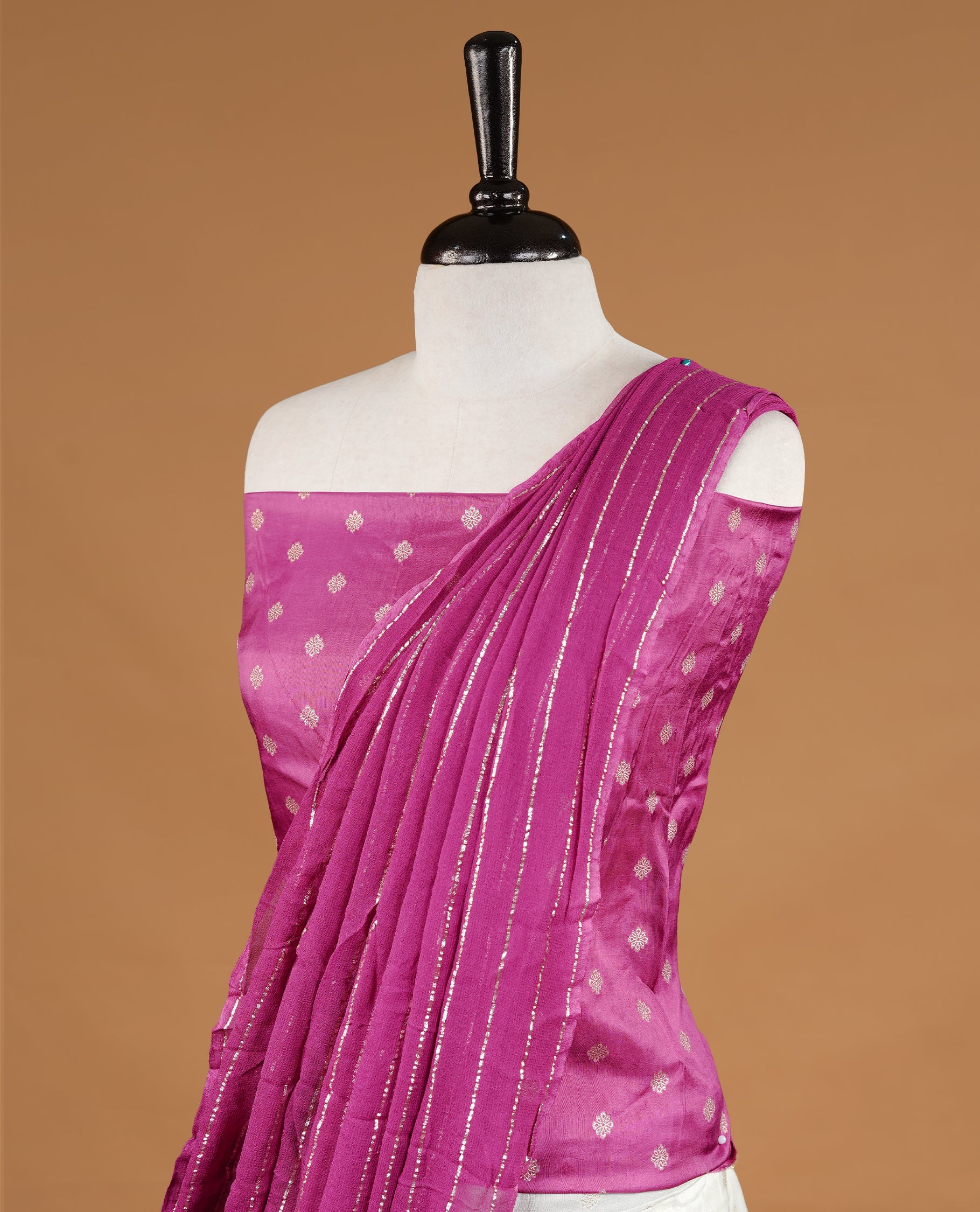 Off White colour semi stitched half saree material featuring delicate zari buttas on the blouse and skirt, paired with a contrast pink zari border and matching striped dupatta