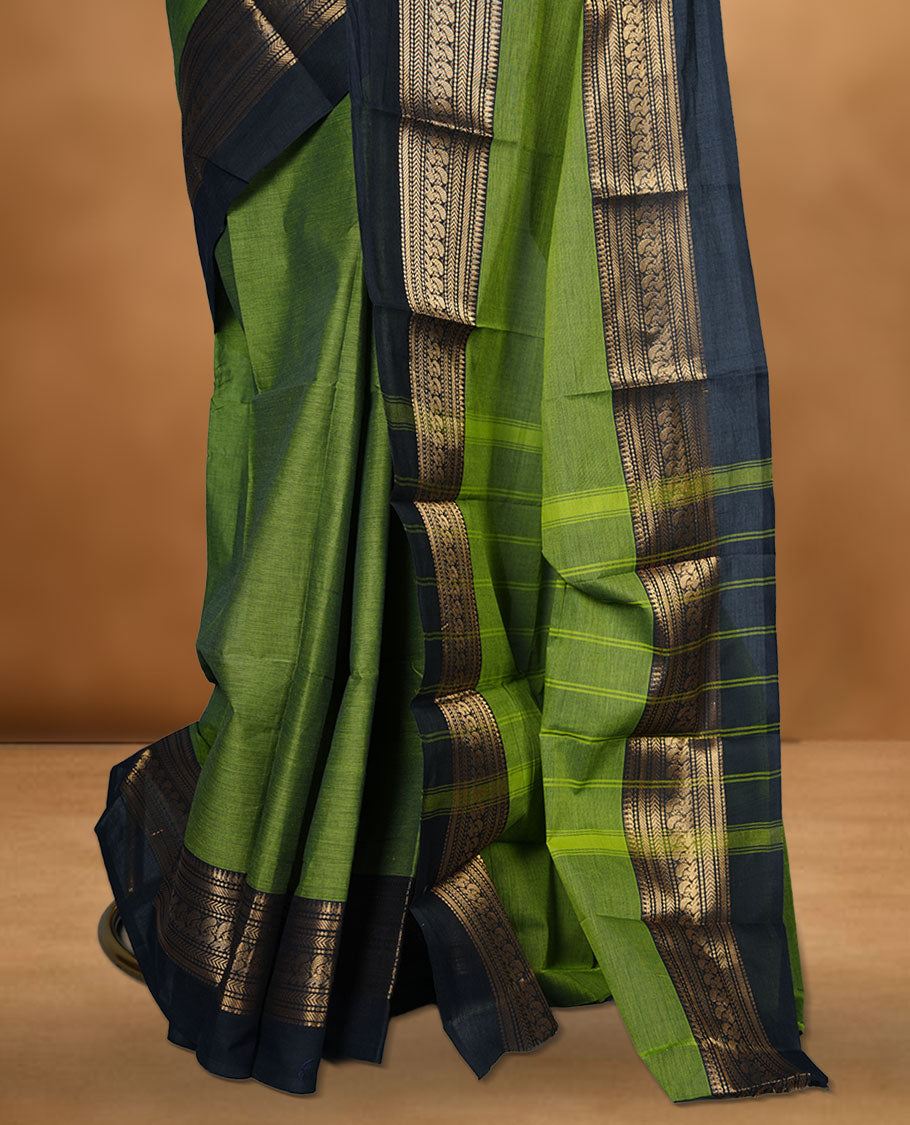 Green colour chettinad cotton saree featuring plain body, paired with a charcoal black colour traditional gold zari border without blouse.