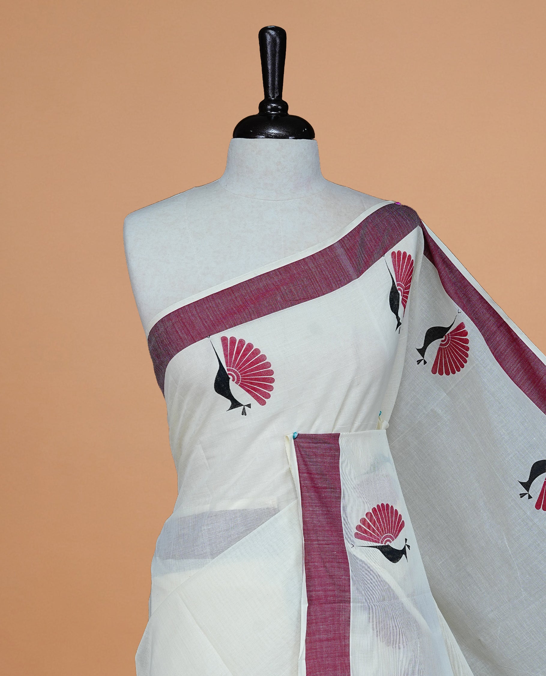 Cream colour Cotton Kerala saree Featuring Classy Plain body for Effortless Elegance, enhancing Maroon with Peacock Printed border, paired with matching blouse piece.