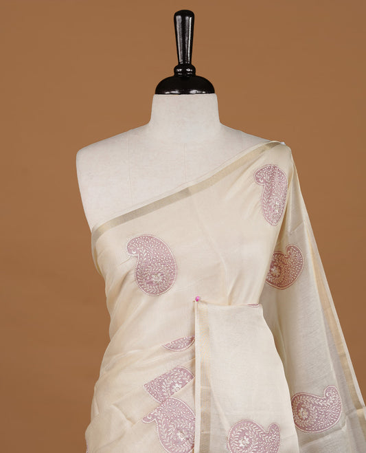 Cream colour Tussar saree featuring Mauve colour Mango pattern with chikankari embroidery work, highlighting gold zari simple border, paired with matching unstitched blouse.