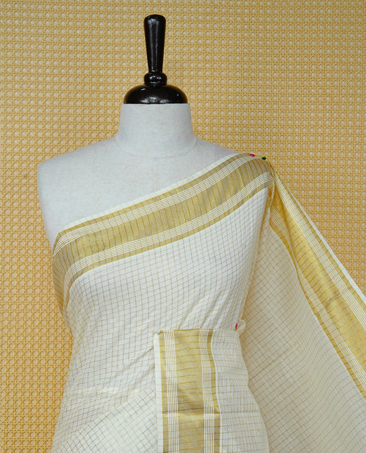 Cream colour Cotton kerala saree featuring Gold zari Checks on body, complemented by Gold zari border & Black with gold zari on Pallu, paired with matching blouse piece.