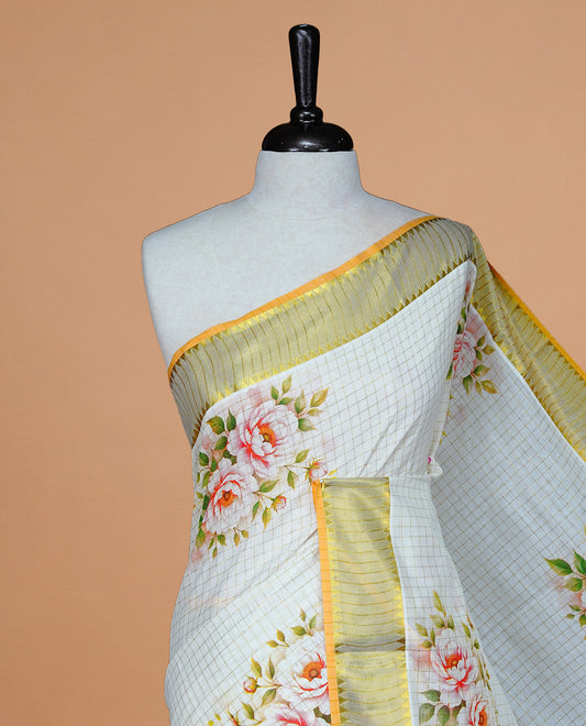 Cream color kerala saree featuring Gold zari Checks on body, enrich Gold zari with floral printed border & pallu, paired with matching blouse piece.