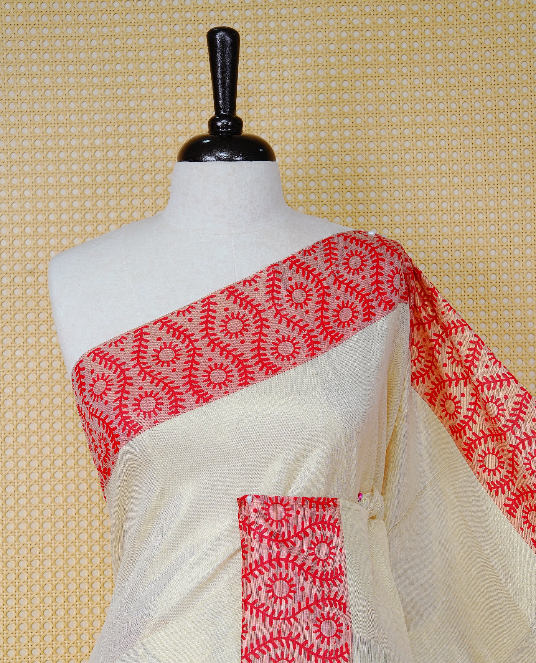 Cream Colour Tissue Kerala Saree Featuring a Plain Body, Enhanced with Red Block  Printed Borders, a Red and Gold Zari Pallu, Red Tassels, and a Matching Blouse Piece.