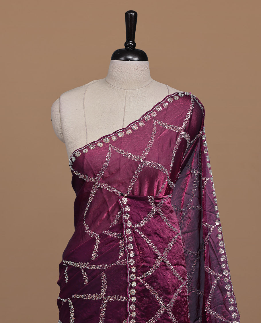 Burgundy colour designer saree featuring Sequins & cut beats worked body, cut beat worked border, paired with matching unstitched blouse.