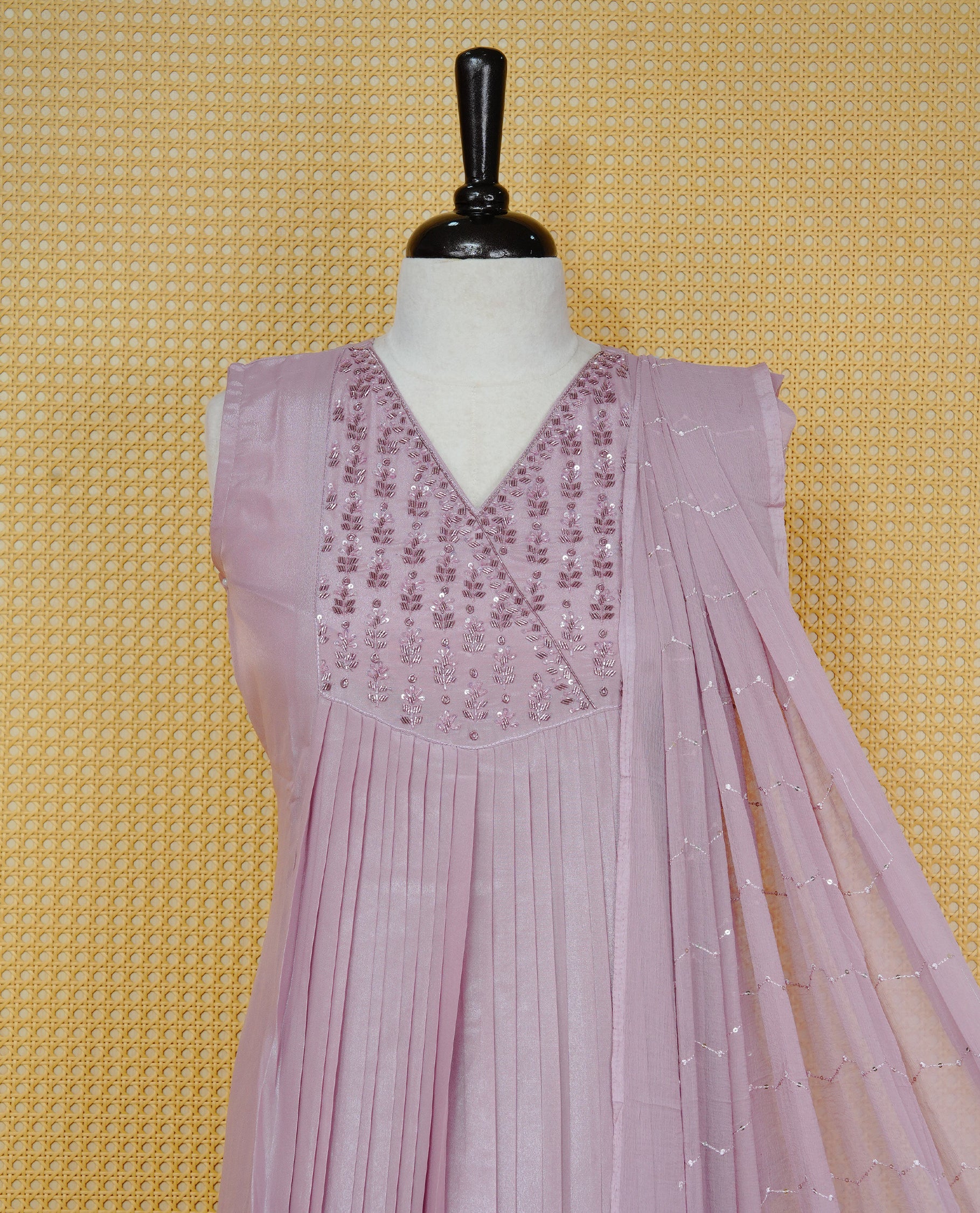 Nude pink colour churidar set with sequins and bead embroidery on the V-neckline, paired with a matching embellished dupatta and solid pants.