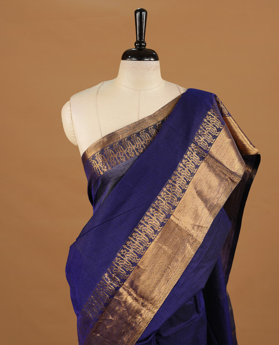 Navy blue colour chettinad cotton saree featuring elegant plain body, complemented by self colour with zari border, paired with matching blouse piece.