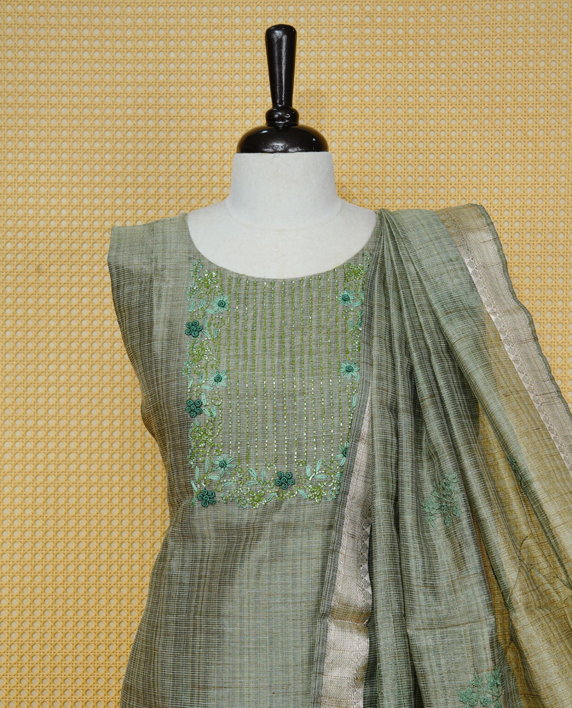 Green colour Tissue Churidar Set featuring delicate floral embroidery and subtle sequin detailing on the yoke, paired with matching solid pants and dupatta.