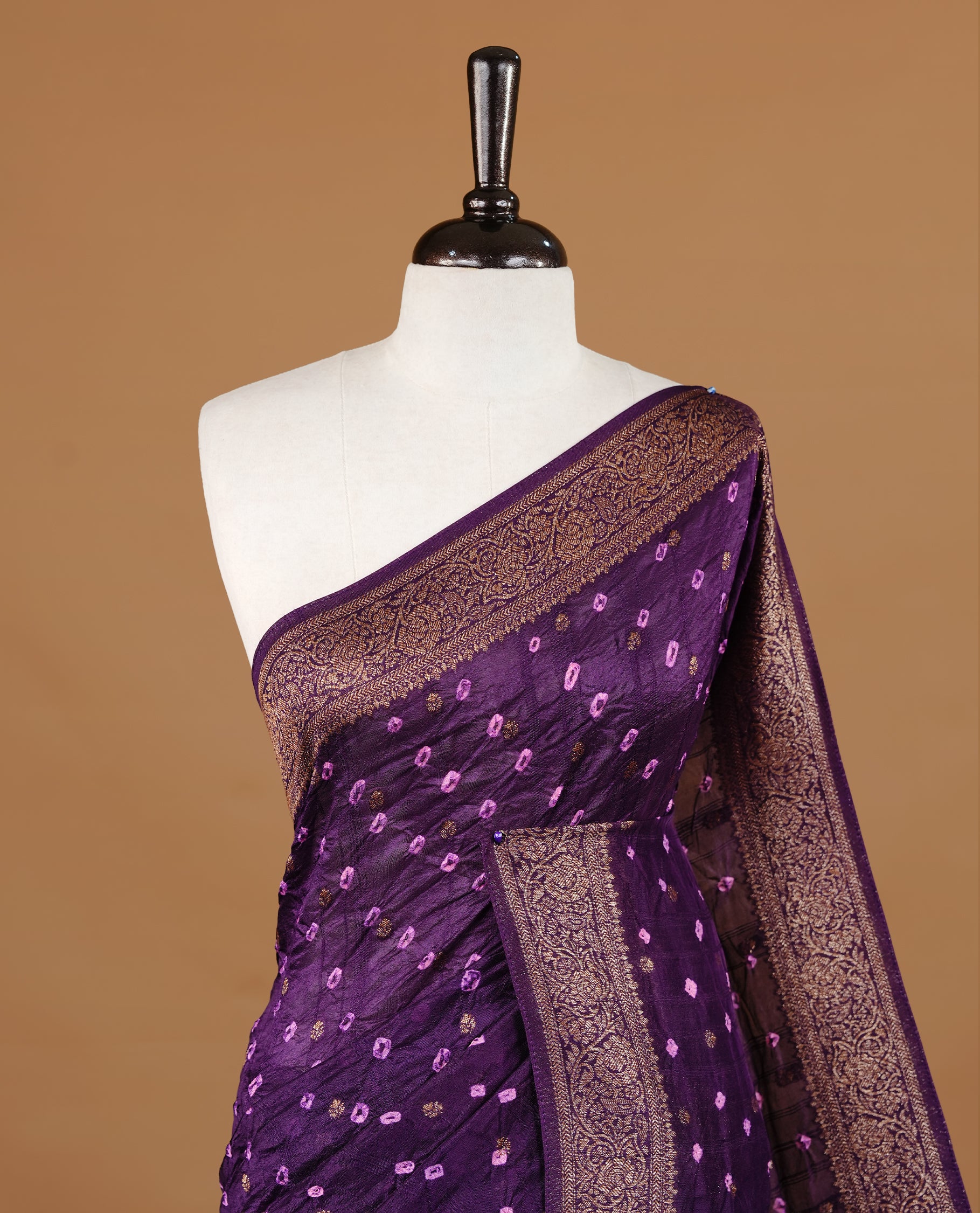 Purple colour Banarasi Bandhani silk saree featuring intricate antique zari circle Buttas across the body, complemented by an elegant antique zari border. Comes paired with a matching blouse piece
