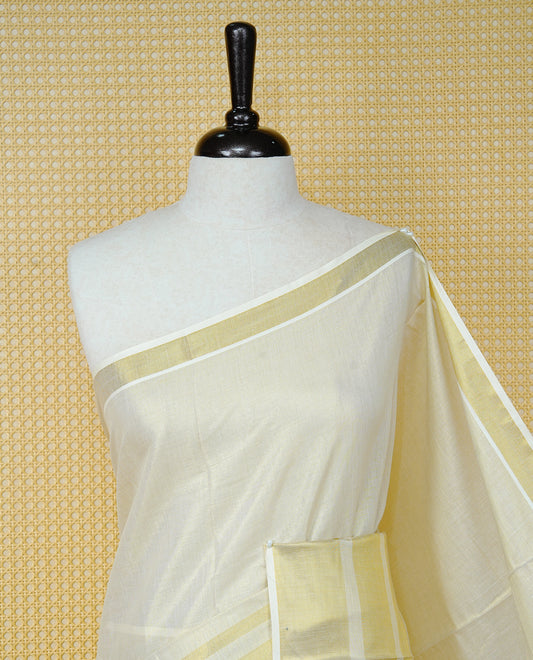 Cream Colour Tissue Kerala Saree Featuring A Classy Plain Body, Beautifully Enhanced With A Traditional Gold Zari Striped Border And Rich Gold Zari Pallu, Finished With Elegant Tassels, Paired With A Matching Blouse Piece.