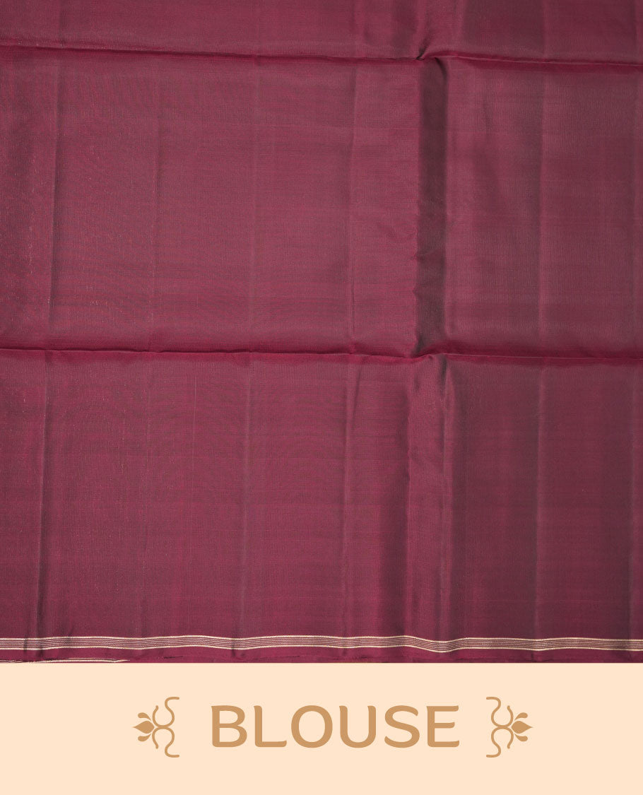 Burgundy colour soft silk saree featuring gold zari motifs on body, complemented by self colour with traditional border with tassel at pallu, paired with matching blouse piece.