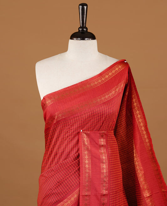 Red colour kalyani cotton saree featuring check pattern on body, highlighting self colour with simple gold zari border, paired with matching blouse piece.