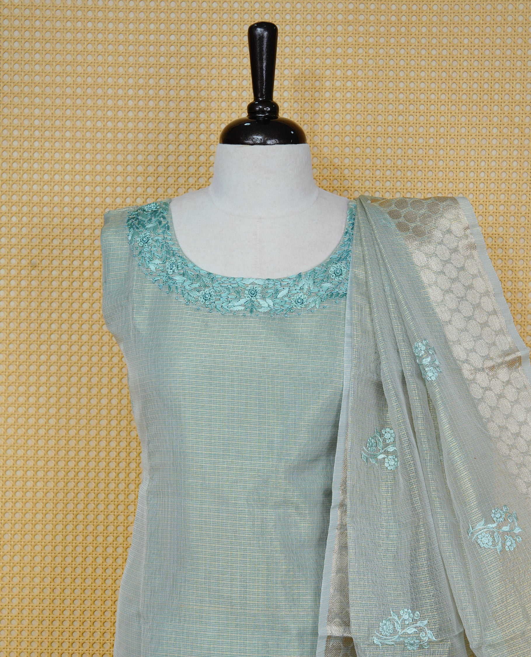 Goldish Pastel Green colour Tissue Churidar set featuring delicate floral embroidery on the round neckline, paired with matching solid pants and dupatta