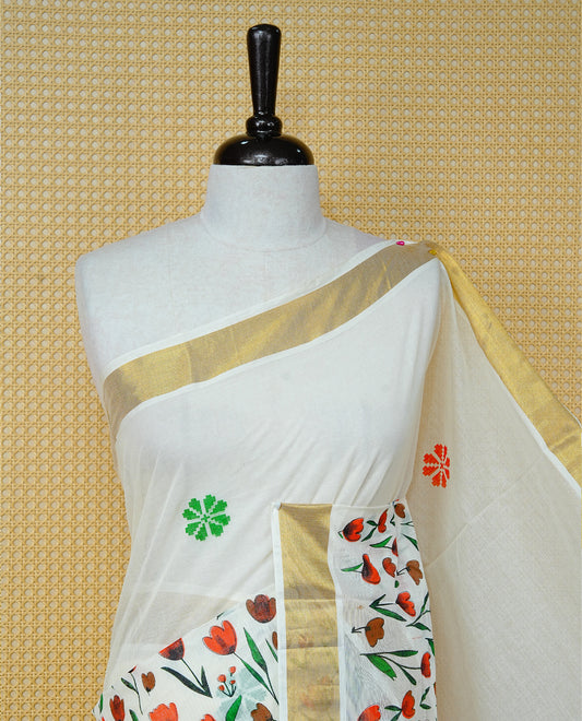 Cream Colour Cotton Kerala Saree Featuring Digital Red & Brown Colour Floral  Motifs On Body, With A Classic Gold Zari Border & A Gold Zari Pallu, Paired With A Matching Blouse Piece.