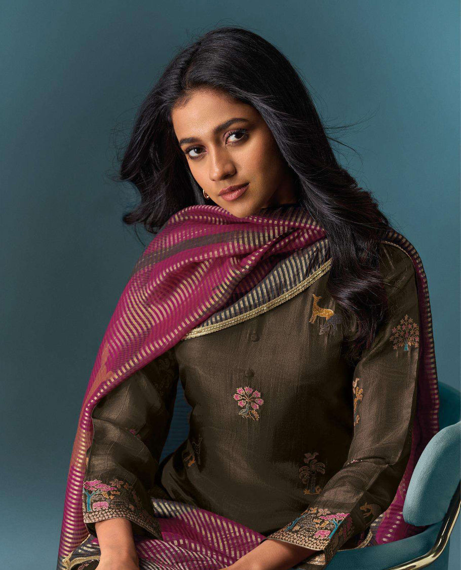 Brown colour suit material with Olivia silk jacquard top featuring elegant digital prints, paired with classic silk bottoms, and completed with a silk jari lining dupatta highlighted by digital prints