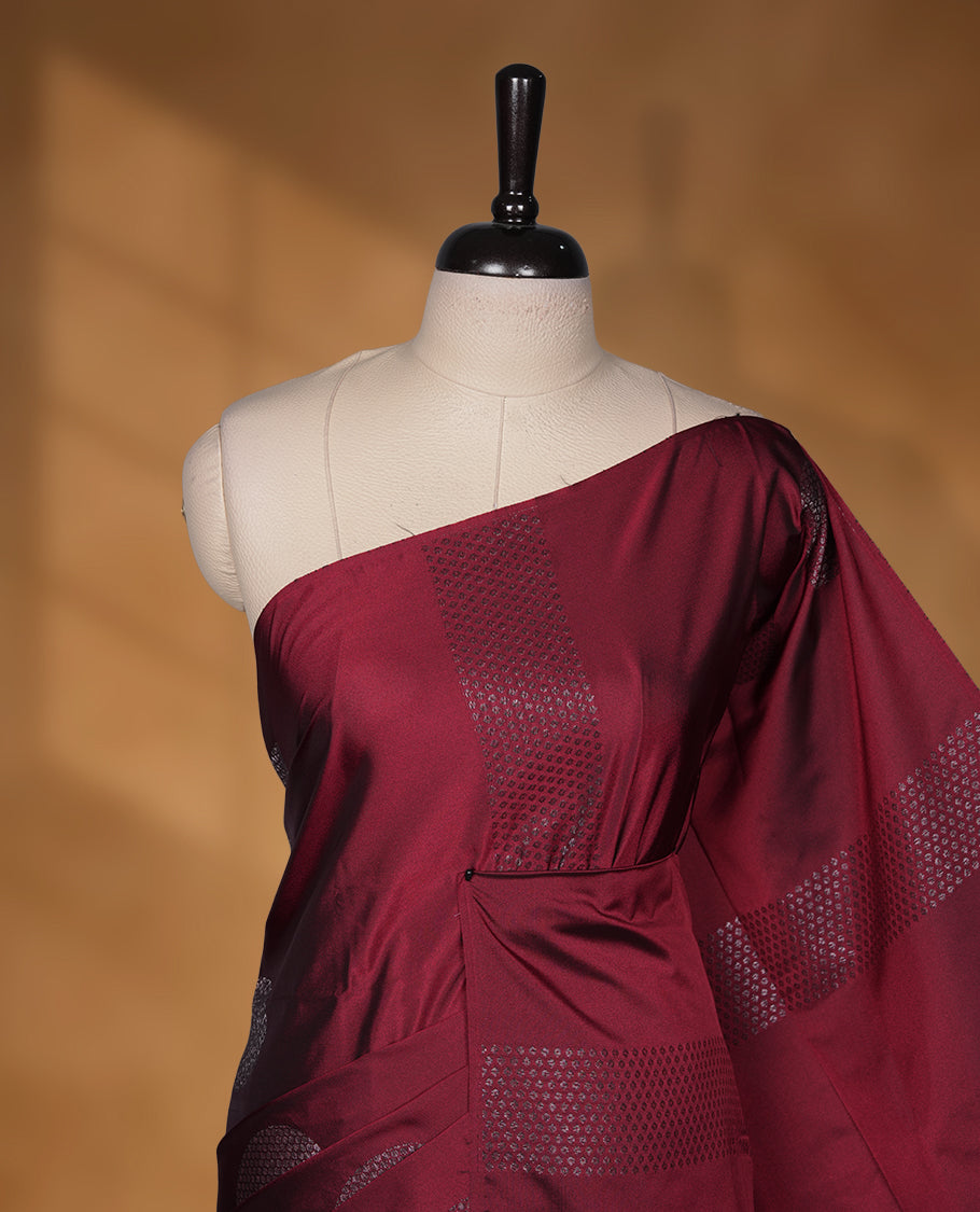Maroon colour soft silk saree featuring Antique zari motifs on body with Highlighting contrast green colour pallu and paired with matching blouse piece.