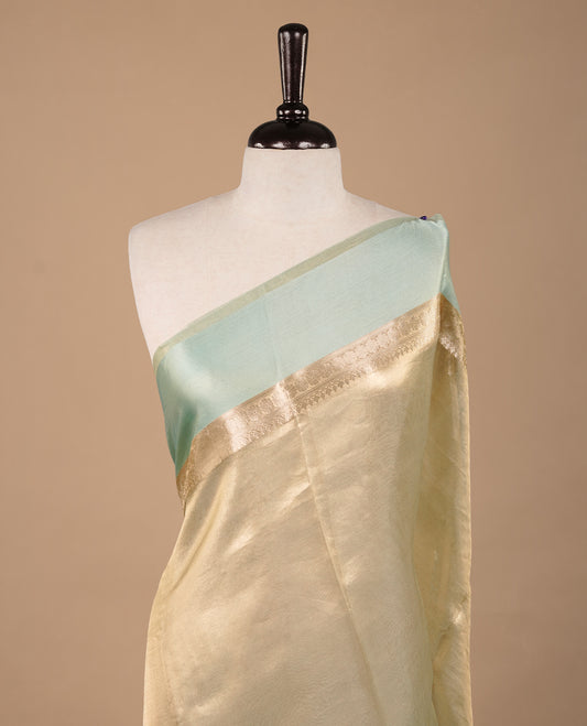 Aqua & gold double shade pure banaras tissue silk saree featuring elegant plain body, complemented by contrast pastel aqua colour gold zari border, paired with matching blouse piece.