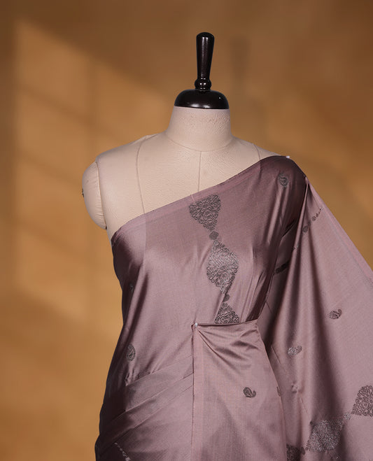 Old rose colour soft silk saree featuring Antique zari motifs on body with Highlighting contrast wine colour pallu and paired with matching blouse piece.