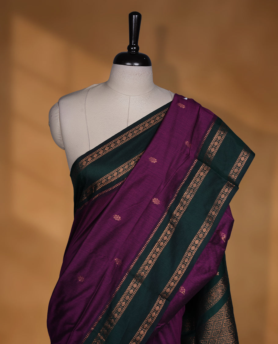 Purple colour mixed Kalyani cotton saree with subtle zari motifs, dark green zari border and rich traditional pallu, paired with a matching blouse.