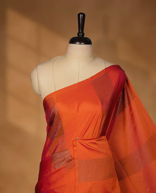 Burnt orange colour soft silk saree featuring Antique zari motifs on body with Highlighting contrast green colour pallu and paired with matching blouse piece.
