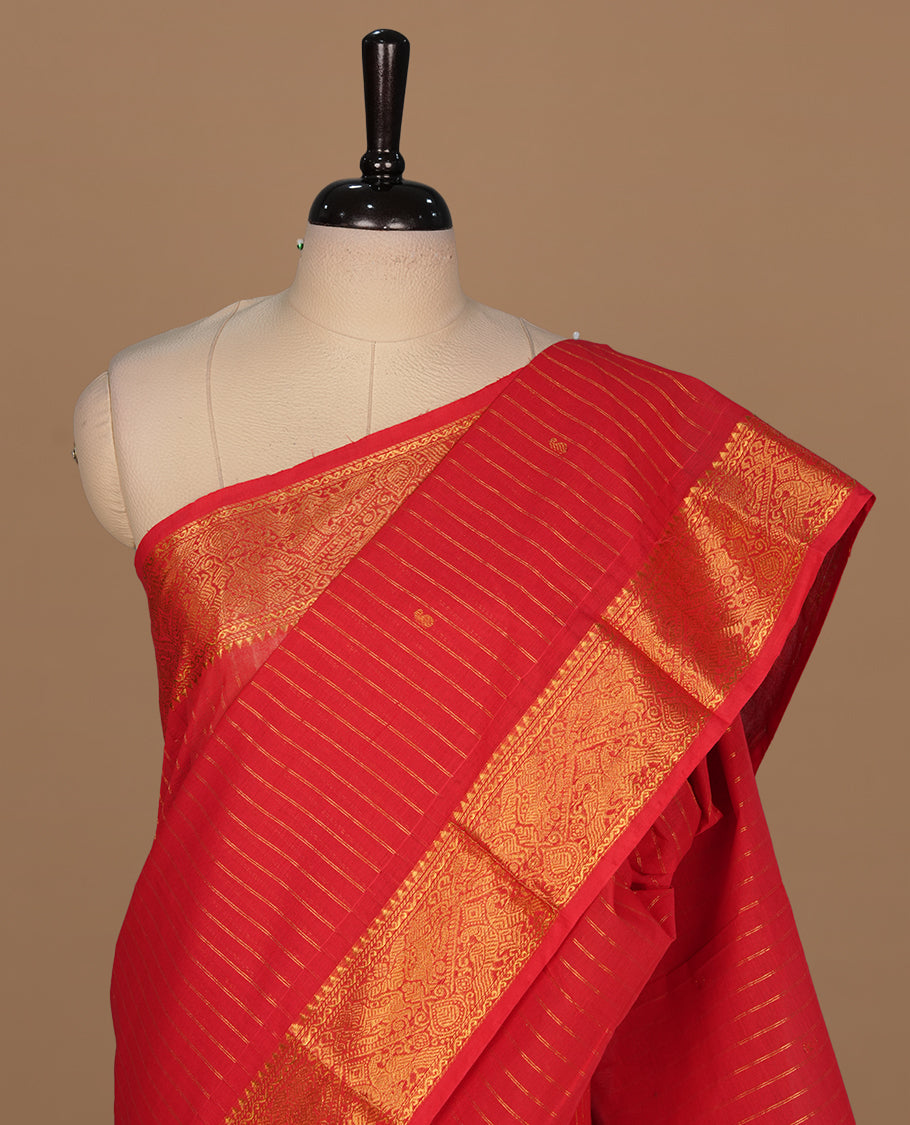 Red colour chettinad cotton saree featuring gold zari stripes on body, self colour with zari border, paired with matching blouse piece.