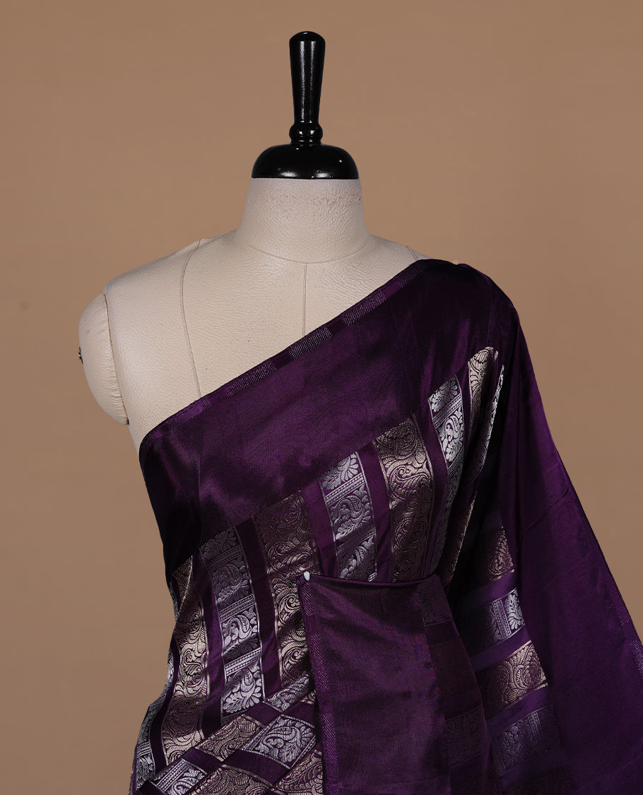 Purple colour banaras crepe saree featuring gold & silver zari design stripes on body, complemented by self colour border, paired with matching blouse piece.