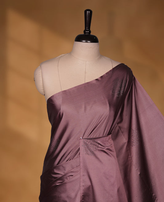 Mauve colour soft silk saree featuring Antique zari motifs on body with Highlighting contrast Plum purple colour pallu and paired with matching blouse piece.