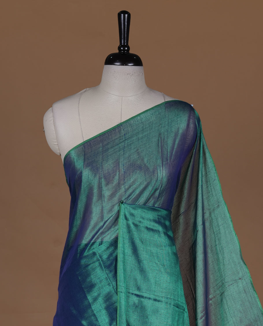 Peacock Green  colour semi tissue saree featuring an elegant plain body, designed without a border and comes without a blouse piece.