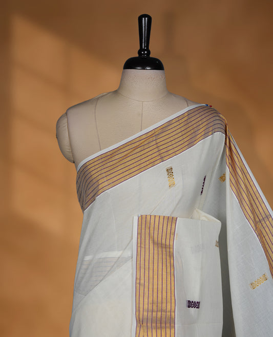 Off white Kerala saree with subtle woven motifs, striped zari border with purple accents, and rich traditional zari pallu, paired with a matching blouse.