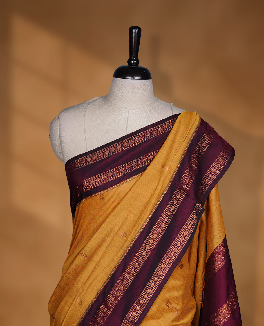 Mustard colour mixed Kalyani cotton saree with subtle zari motifs, maroon zari border and rich traditional pallu, paired with a matching blouse.