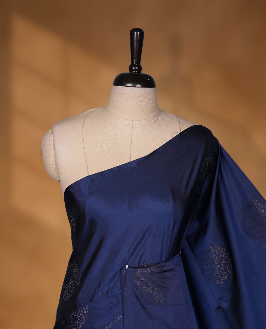 Navy blue colour soft silk saree featuring Antique zari motifs on body with Highlighting contrast Pink colour pallu and paired with matching blouse piece.