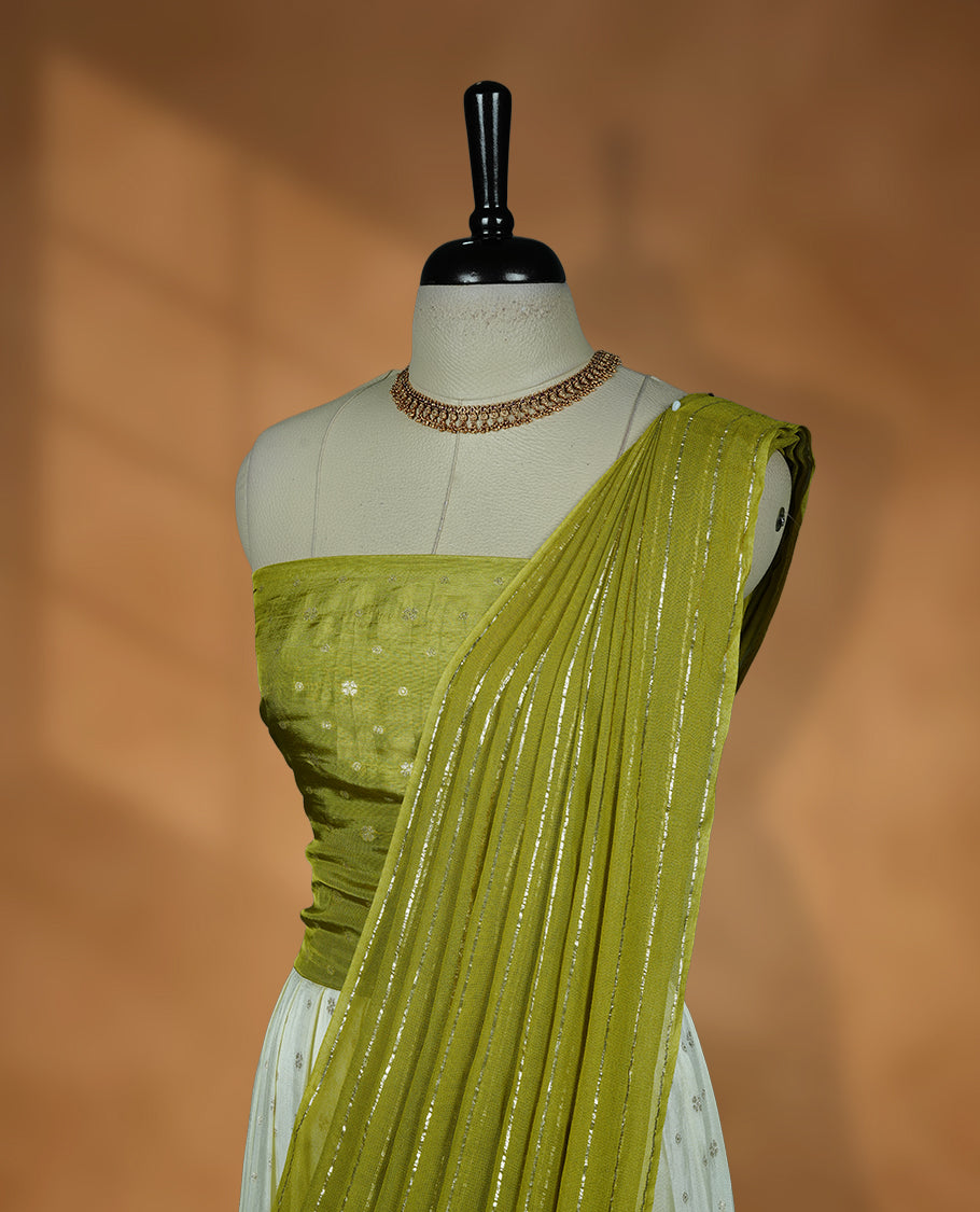 Off white semi banaras semi stitched dhavani set featuring gold zari motifs and contrast Olive colour border, unstitched gold zari blouse piece and matching Duptta with gold zari stripes.