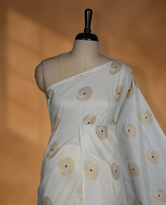 Off white Cotton Kerala saree featuring circular zari motifs, complemented by a rich geometric zari border and traditional pallu, paired with a matching blouse.