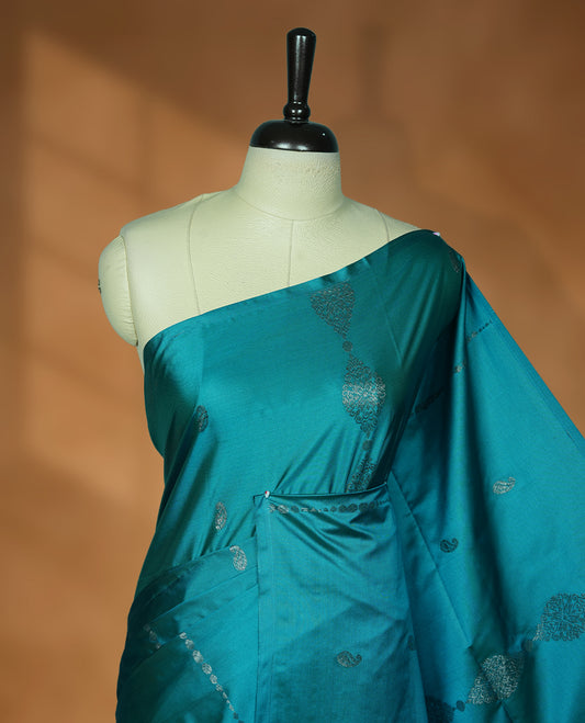Aqua green colour soft silk saree featuring Antique zari motifs on body with Highlighting contrast Dark purple colour pallu and paired with matching blouse piece.