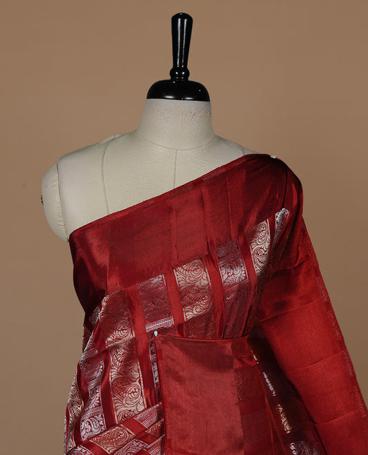 Red colour banaras crepe saree featuring gold & silver zari design stripes on body, complemented by self colour border, paired with matching blouse piece.