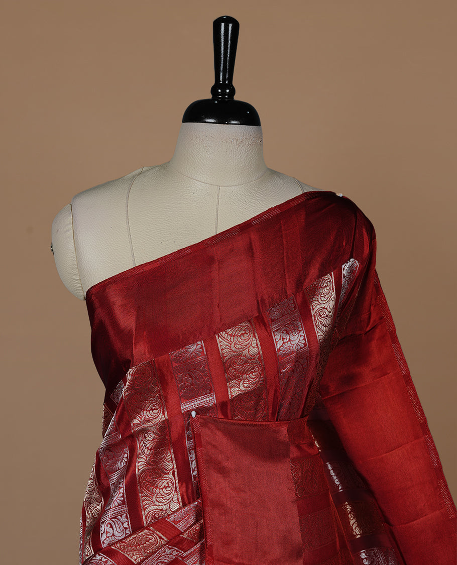 Red colour banaras crepe saree featuring gold & silver zari design stripes on body, complemented by self colour border, paired with matching blouse piece.