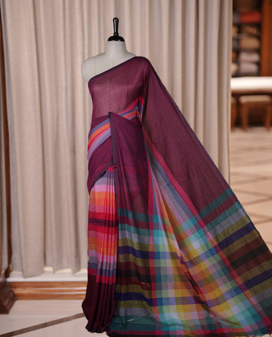 Wine colour soft cotton saree with rainbow colored horizontal lines on the body, a vibrant multicolor pallu, and a subtle border & Elegant and lightweight, this saree comes without a blouse piece for a customizable style.
