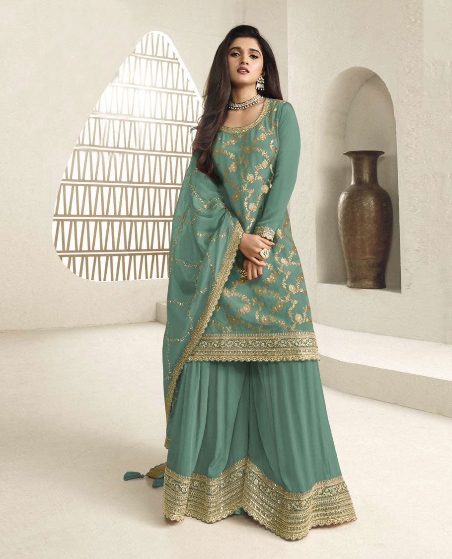 Pine green colour semi stitched salwar suit featuring an embroidered chinon top material paired with a matching sharara  bottom, and dupatta.