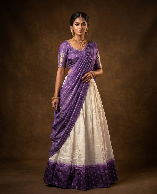 Off White colour half saree material featuring delicate zari buttas on the blouse and skirt, paired with a contrast Lavender zari border and matching small zari motifs dupatta