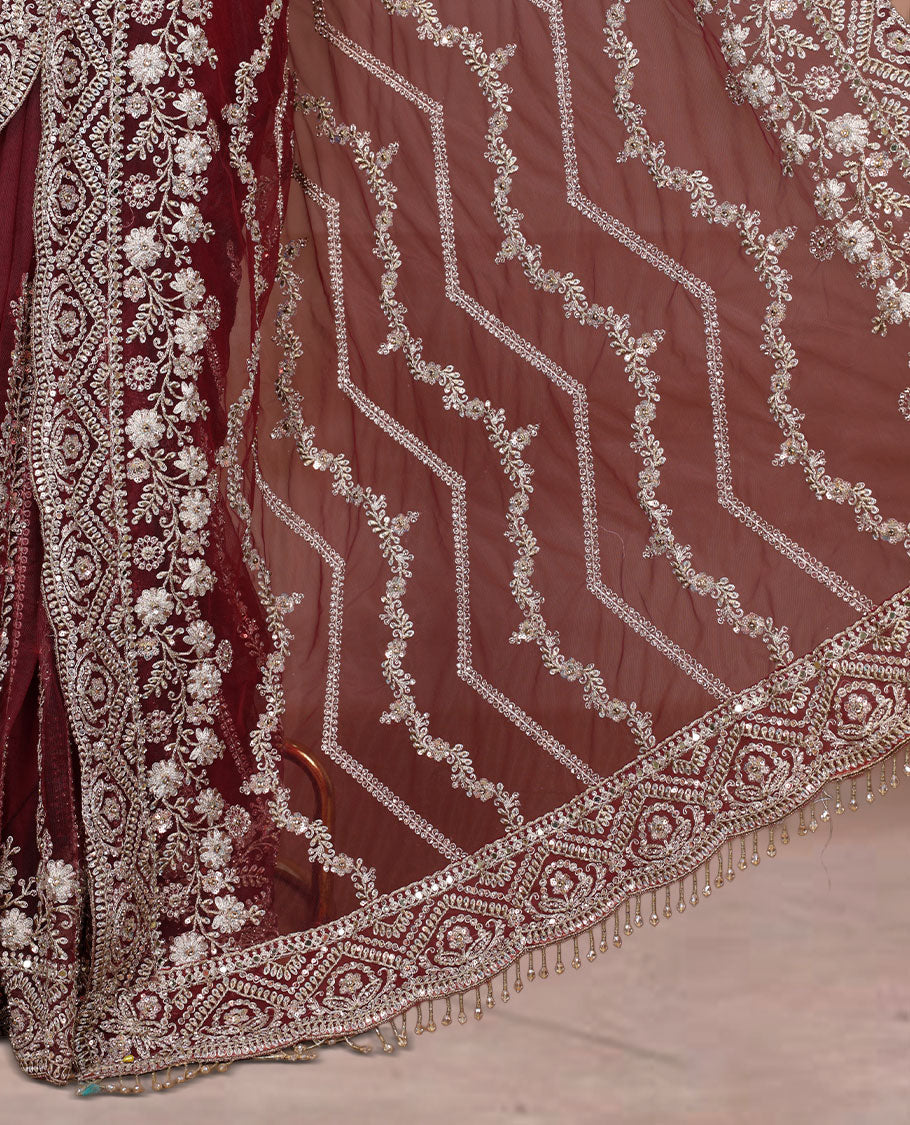 Maroon Colour net designer Wedding saree featuring all over floral embroidery with sequin detailing and an ornate scalloped border, finished with a matching embellished blouse.