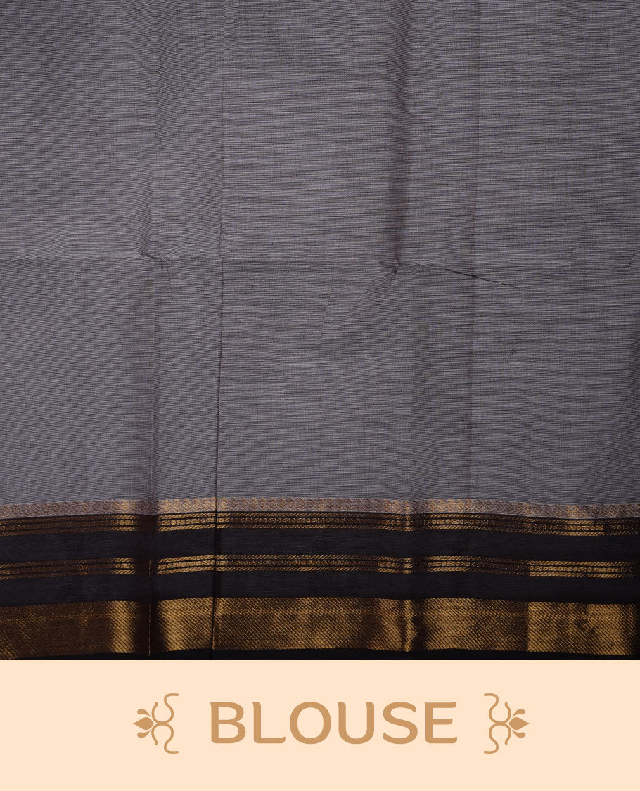 Grey colour chettinad cotton saree featuring small black buttas on body highlighting contrast dark chocolate colour with gold zari traditional border, pallu and paired with matching blouse piece.
