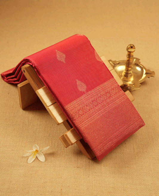 Red Colour Manthrakodi saree featuring tissue weaving with traditional motifs on the body, complemented by a self coloured traditional border and a matching self coloured blouse.