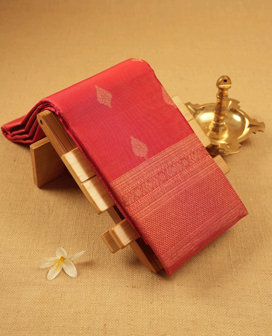 Red Colour Manthrakodi saree featuring tissue weaving with traditional motifs on the body, complemented by a self coloured traditional border and a matching self coloured blouse.