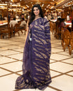 Violet colour sheer Organza saree featuring Gold thread embroidery with modern wavy & flame inspired motifs and scallop border, comes with matching organza blouse.