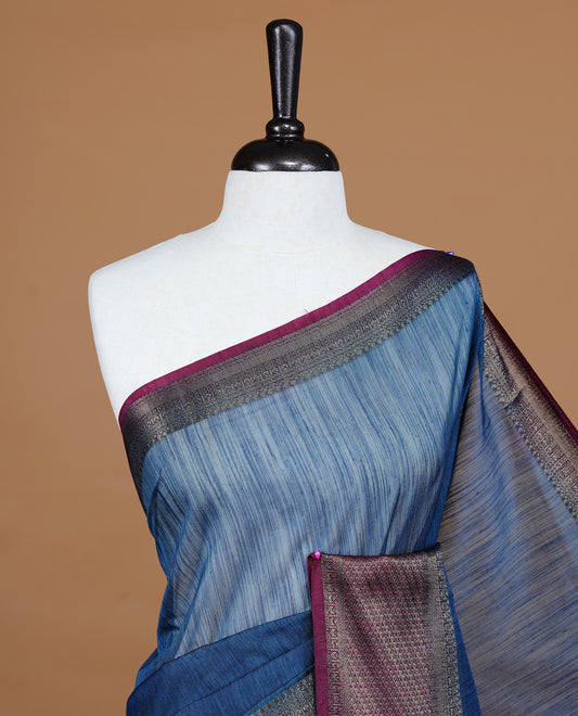 Teal colour Semi linen saree featuring Elegant plain body, complemented by contrast Maroon colour With Antique zari border, paired with matching blouse piece.